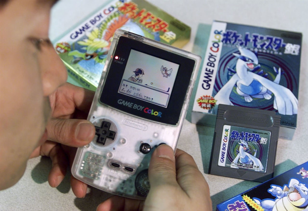 A person plays the Japanese version of Pokemon Silver.