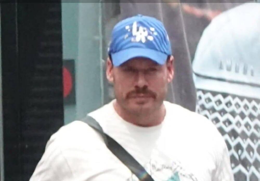 A man in casual wear with his hands in his pockets