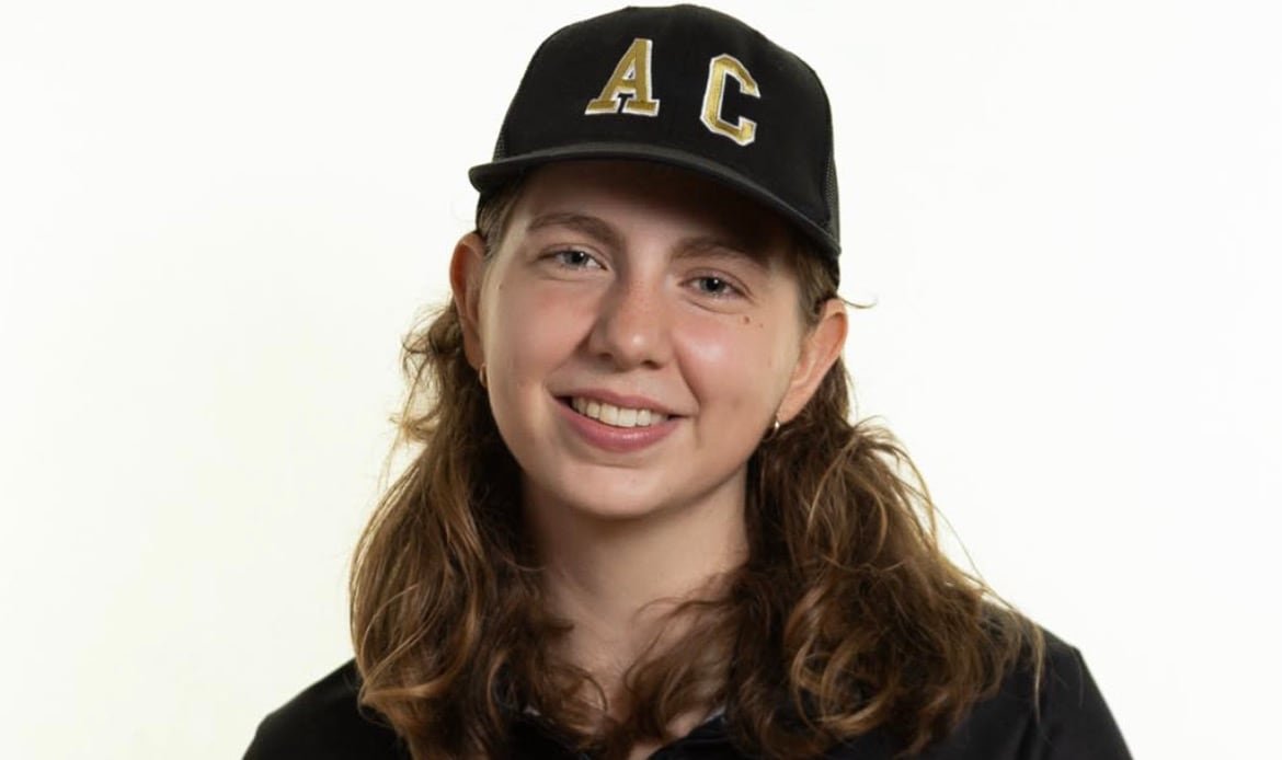 A woman wears a ball cap that says AC (agricultural campus) and a sweater that says Dal AC.