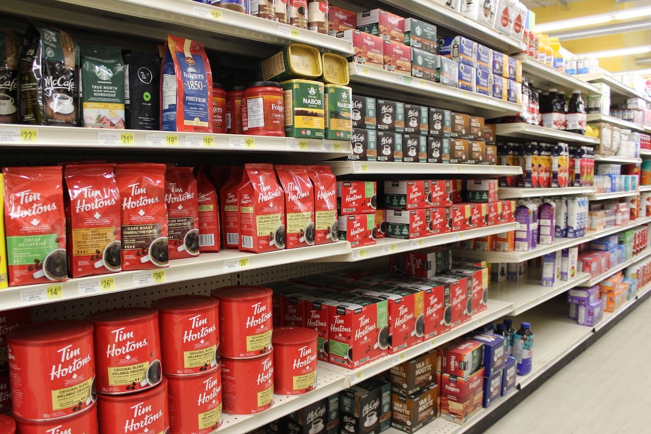 Shelves of coffee available for purchase in a supermarket