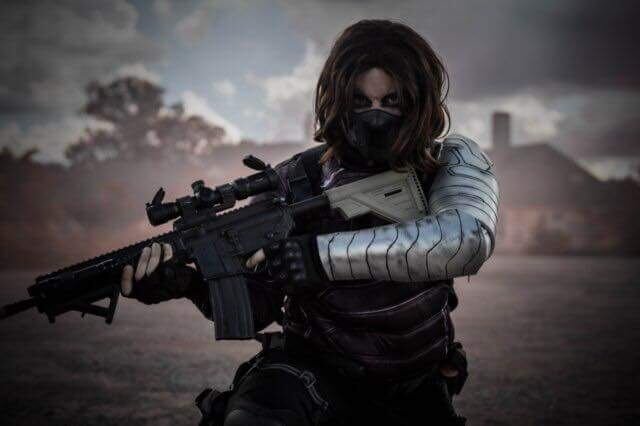A person holding a gun with a metallic-looking arm